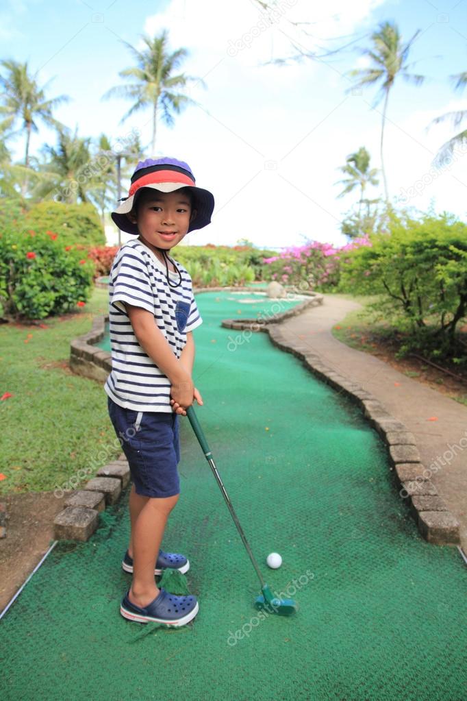 Japanese boy playing with putting golf (5 years old)