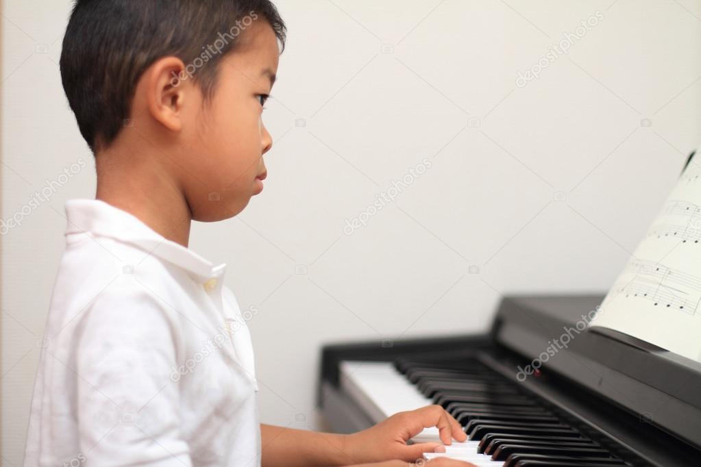 Japanese boy playing a piano (5 years old)