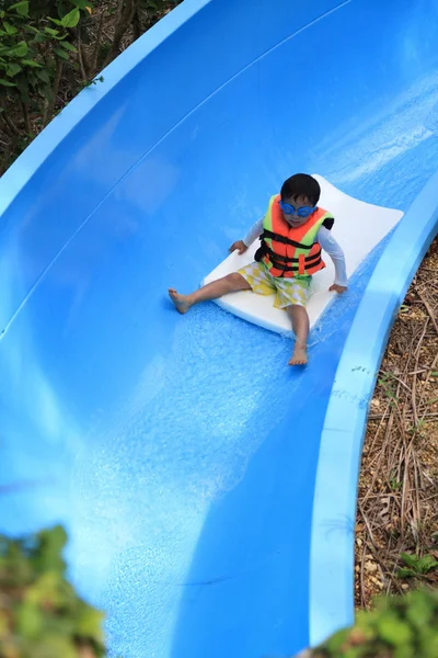 Japanese boy on the water slide (5 years old) — Stock Photo, Image