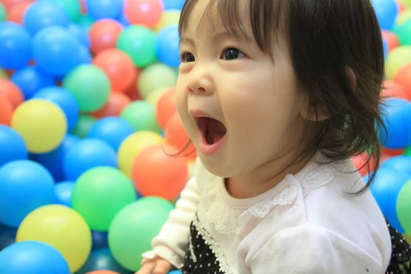 Japanese baby girl playing in ball pool (1 year old) — Stock Photo, Image