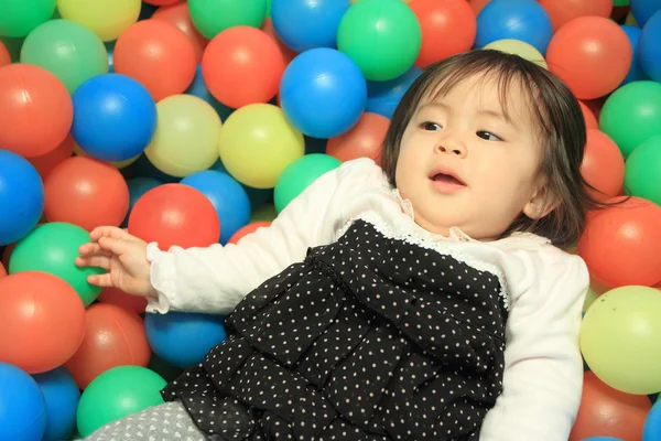 Japanese baby girl playing in ball pool (1 year old) — Stock Photo, Image