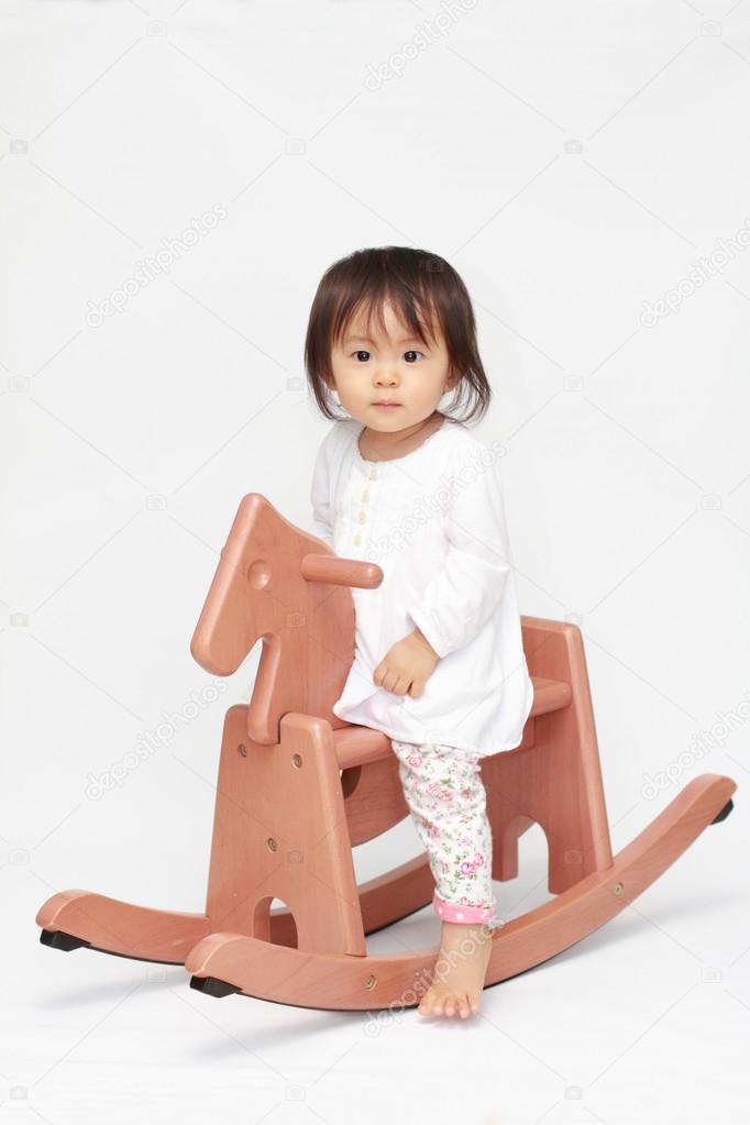 Japanese baby girl playing with rocking horse (0 year old)