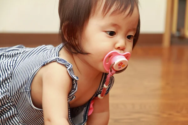 Japanese baby girl sucking on a pacifier (0 year old) — Stock Photo, Image