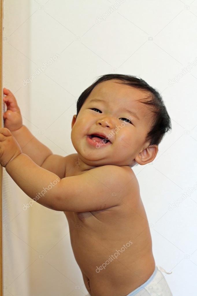 Japanese baby boy pulling up to stand (0 year old)