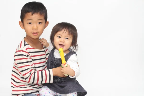 Japonés hermano y hermana abrazándose entre sí (6 años de edad, niño y 1 año de edad, niña ) —  Fotos de Stock