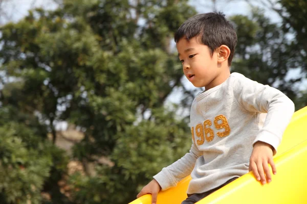 Japanese boy on the slide (6 years old) — Stock Photo, Image