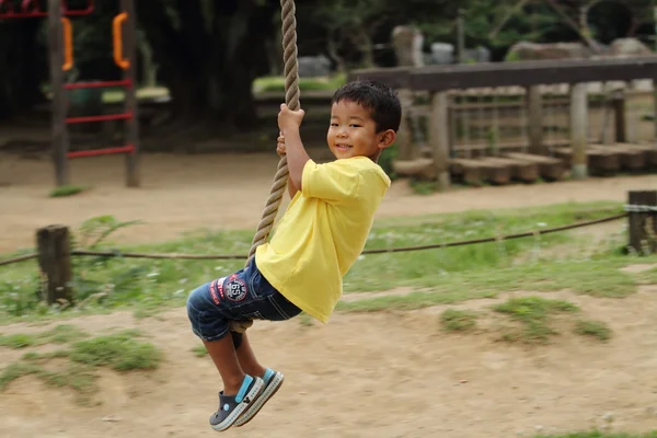 Japanese boy playing with Tarzan rope (3 years old) — Stock Photo, Image