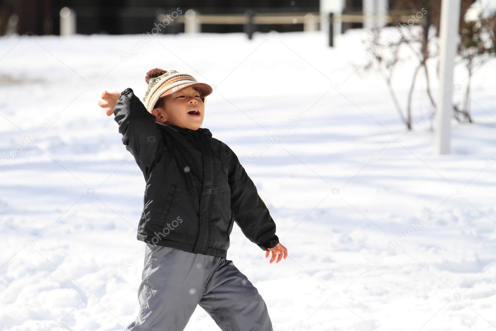 Japanese boy having snowball fight (4 years old)