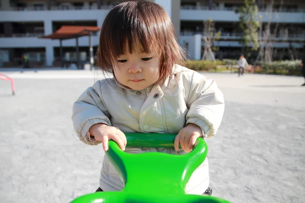 Japanese baby girl on the seesaw (1 year old) — Stock Photo, Image