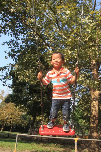 Japanese boy on the swing (3 years old) — Stock Photo, Image