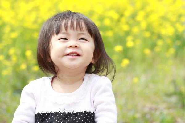 Menina japonesa (1 ano de idade) e mostarda campo amarelo — Fotografia de Stock