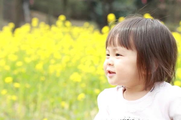 Menina japonesa (1 ano de idade) e mostarda campo amarelo — Fotografia de Stock