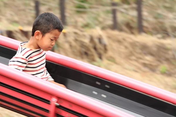 Japanese boy on the slide — Stock Photo, Image