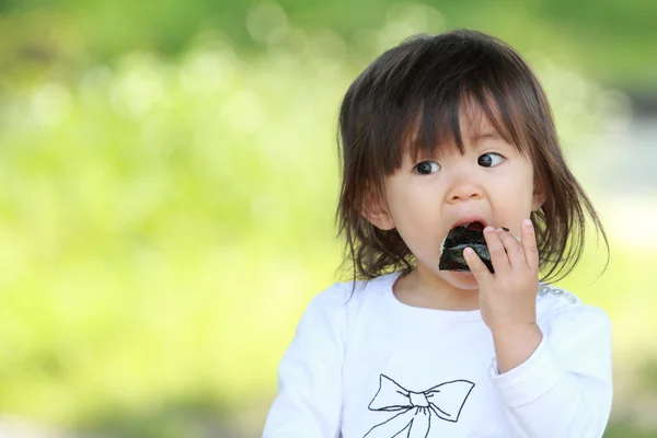 Menina japonesa comer bola de arroz (1 ano de idade ) — Fotografia de Stock