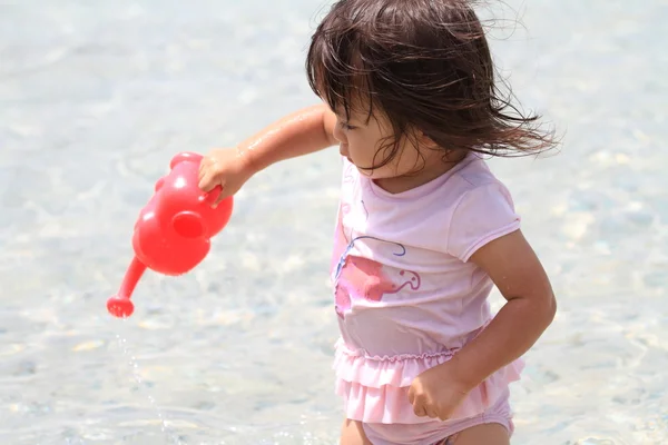 Japansk flicka som leker med vatten med långtidsvattnande kruka (1 år gammal) — Stockfoto