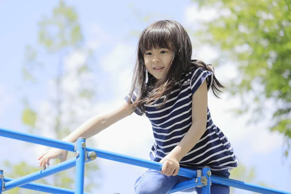 Japanese student girl on the jungle gym (6 years old)