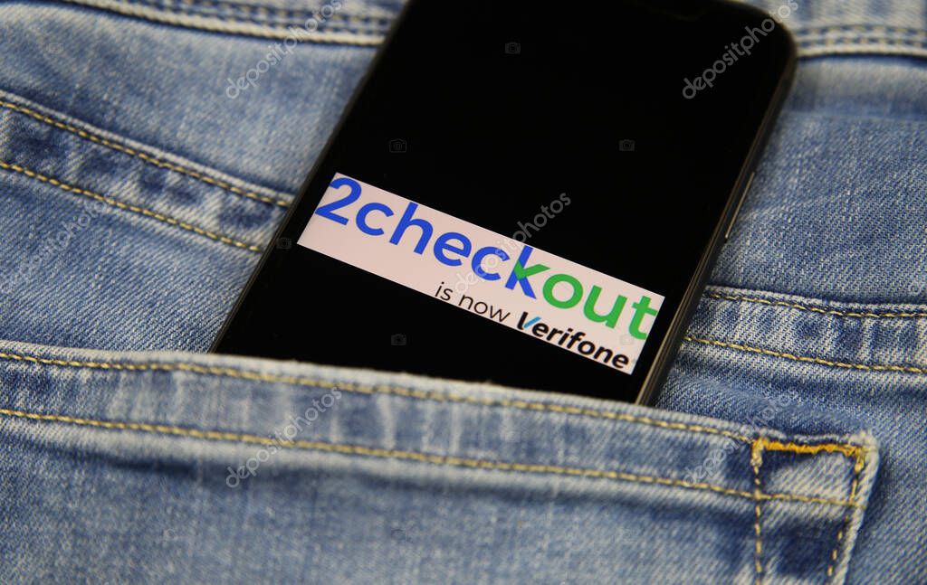 Viersen, Germany - November 9. 2020: Close up of isolated mobile phone with payment provider 2checkout logo lettering in jeans pocket