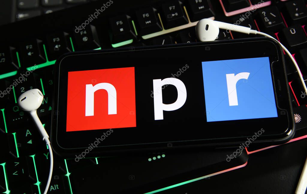 Viersen, Germany - January 9. 2021: Closeup of smartphone screen with logo lettering of independant online radio broadcast service npr on computer keyboard