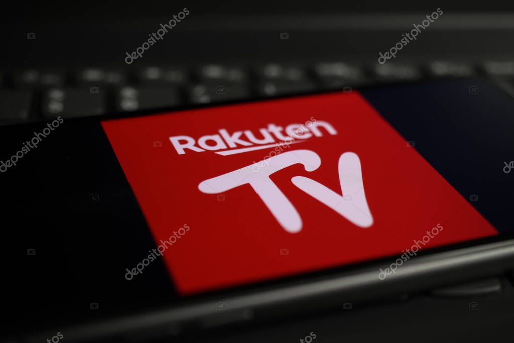 Viersen, Germany - March 1. 2021: Closeup of smartphone screen with logo lettering of online streaming service rakuten on computer keyboard