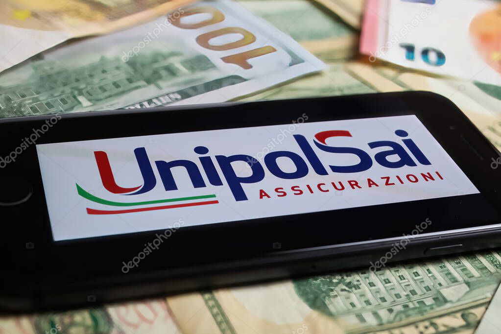 Viersen, Germany - March 1. 2021: Closeup of smartphone with logo lettering of unipolsai insurance company on paper money currency
