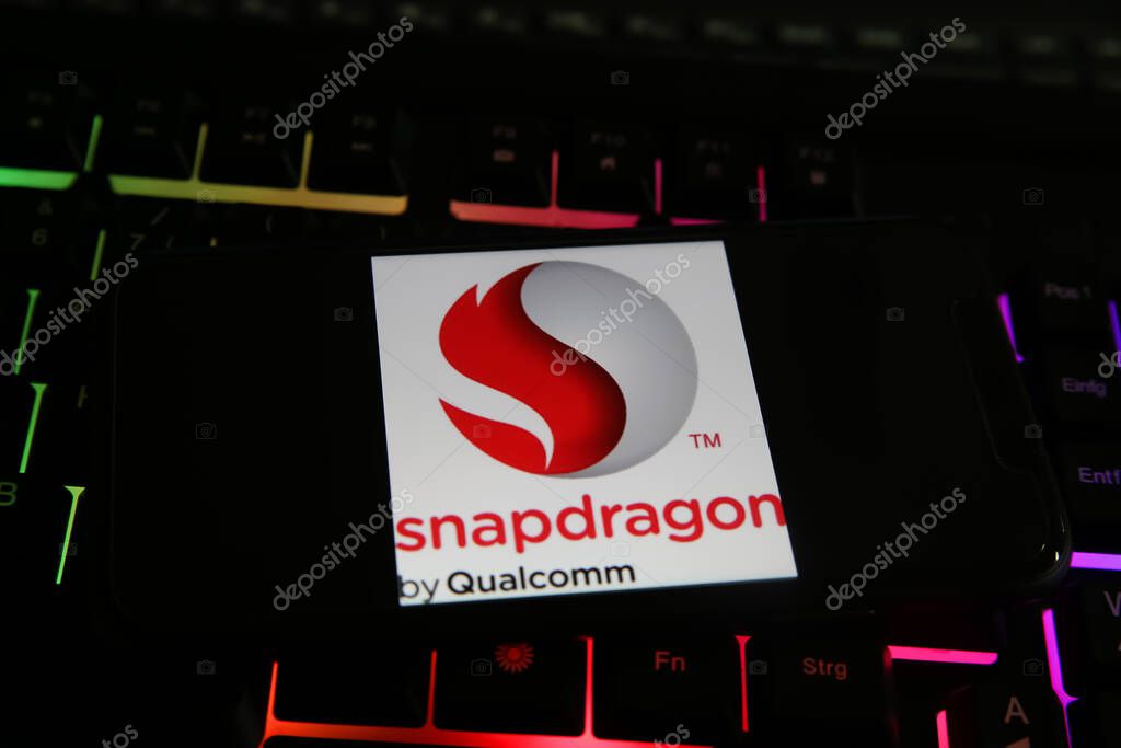 Viersen, Germany - May 8. 2021: Closeup of smartphone with logo lettering of snapdragon qualcomm processor cpu on computer keyboard