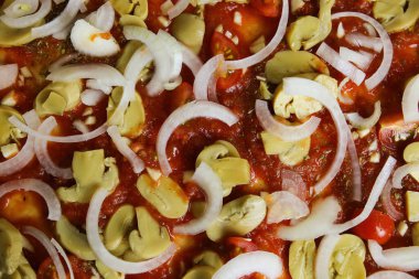 Vejetaryen, çiğ, ev yapımı, taze ve temel malzemeli pizza, domates sosu, soğan ve şampiyon.