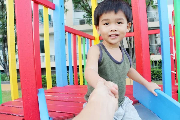 Little Asian Boy Sitting Playground Blurry Hand Father Takes Care — 图库照片