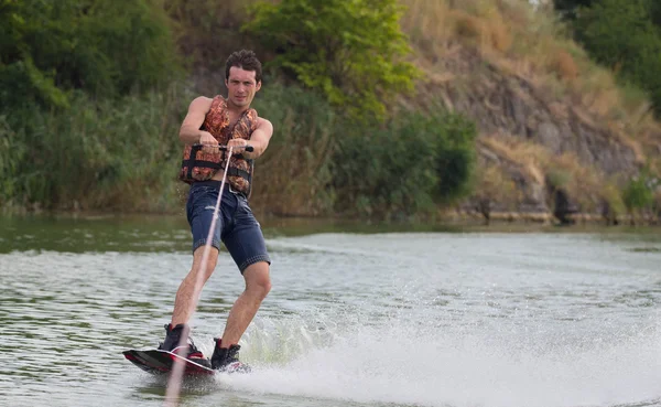 Yeşil parkta gölet erkek wakeboarder.
