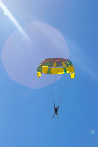 Deniz beach yakınındaki mavi gökyüzünde parasailing. — Stok fotoğraf