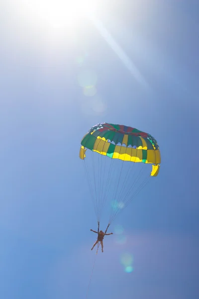 Parasailing i en blå himmel nära stranden. — Stockfoto