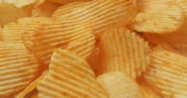 Close up potato chips top view background.