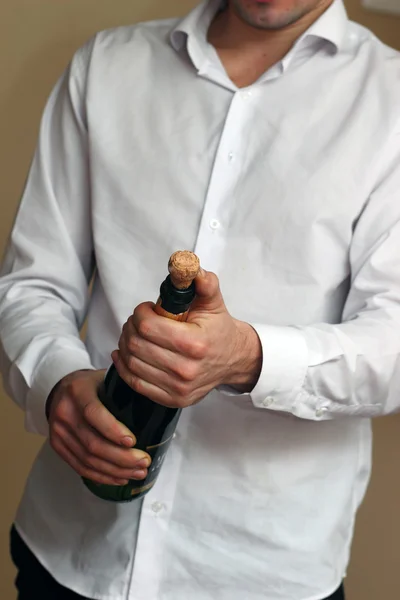 A Waiter in white shirt opens a Bottle of Champagne — Stock Photo, Image