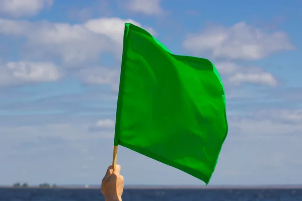 Bandeira verde acenando no céu . — Fotografia de Stock