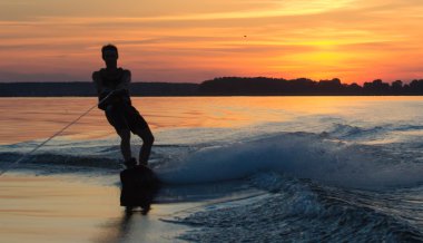 Wakeboarder günbatımı üzerinde hileler yapmak