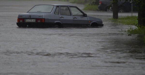 car rides in heavy rain on a flooded road