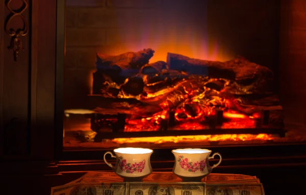 Two cups of hot drink near fireplace. — Stock Photo, Image