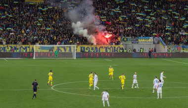 LVIV, UKRAINE - NOWEMBER 14: Terrorists fans disrupted  football match Ukraine Slovenia burning and explosion  fireworks packages. Bate on Nowember 14, 2015  Lviv, Ukraine clipart