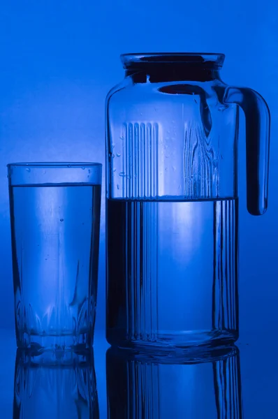 Pouring water into Glass of water — Stock Photo, Image