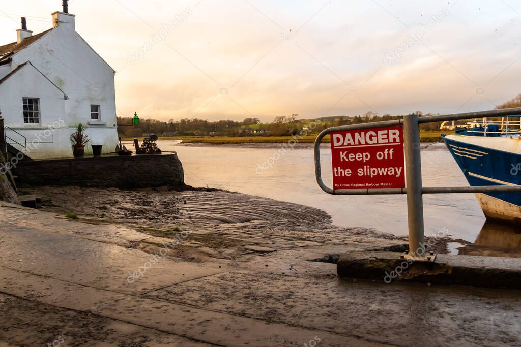 Danger Keep off the slipway sign at Kirkcudbright Harbour on a winters afternoon, Scotland