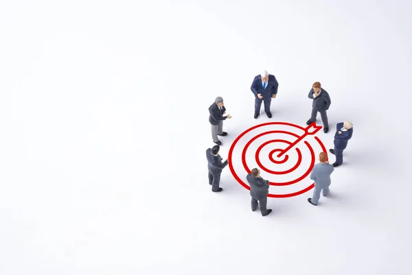 Concentrate setup objectives target and business goal ,Manager miniature figures standing and see in virtual red arrow and dartboard which print screen on white background.