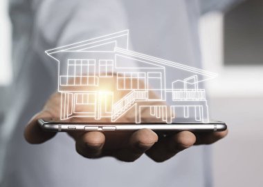 Akıllı telefondan sanal bilgi edinme evi işletiliyor. Gayrimenkul yatırım kavramı.