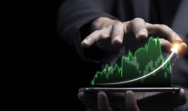 Ekonomik ve kar yatırım büyüme konsepti, iş adamı renkli grafikle akıllı telefon tutuyor.