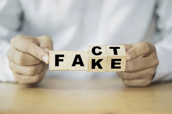 Businessman Hand Flipping Wooden Cubes Change Wording Fake Fact — Stock Photo, Image