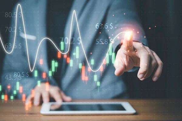 Businessman touching stock market technical chart on virtual screen of tablet for analysis financial information data , Value investor concept.