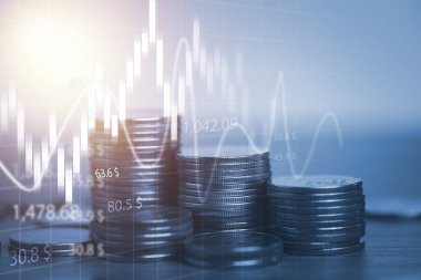 Borsa yatırımı ve finansal konsept için madeni paraların istiflenmesi ve teknik grafik.