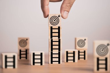 Tahta küp bloktaki ekranı yazdıran merdivenin tepesine hedef tahtasını koymak, iş ve hayat konseptinde meydan okumayı başarma hedefini kurmak.