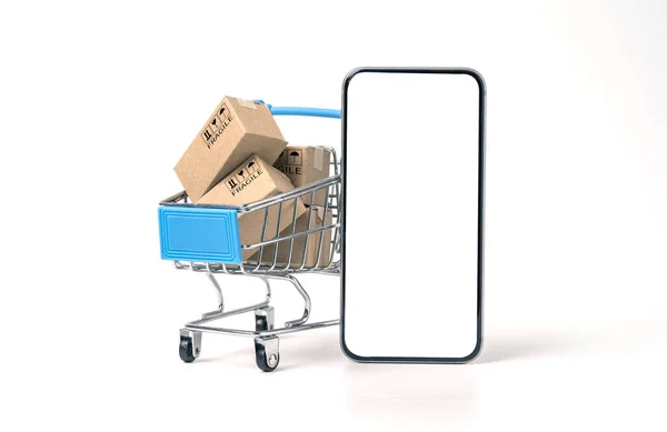 白い背景にショッピングトロリーの中にモックアップと小さなカートンボックスのための空白の画面を持つスマートフォン オンラインショッピングと電子商取引の概念 — ストック写真