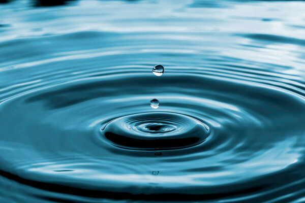 Closeup of transparent water droplet on water ring surface , Natural concept.