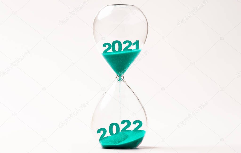 Hourglass with blue sand for change 2021 to 2022 year , Countdown and preparation merry Christmas and happy new year concept.