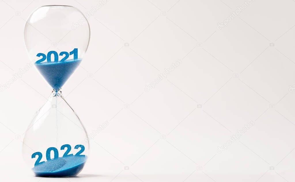 Hourglass with blue sand for change 2021 to 2022 year , Countdown and preparation merry Christmas and happy new year concept.